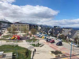 a town with cars parked in a parking lot at Olivia View II in Ushuaia