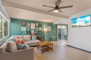 a living room with a couch and a ceiling fan at Beach meets Fabulous in Oceanside