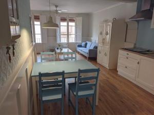 a kitchen and living room with a table and chairs at Reus, cosy apartment in the city's centre in Reus