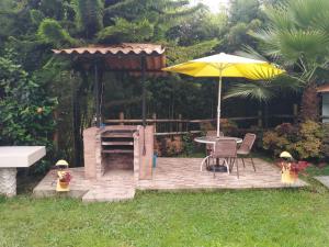 a patio with a table and an umbrella at Jamaica in Fusagasuga
