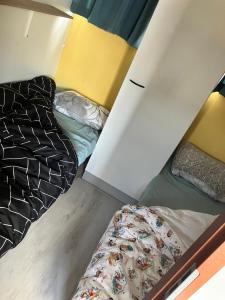 two beds are in a room with a wall at Beach house in Zandvoort