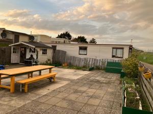 a picnic table in a backyard with a house at Beach house in Zandvoort