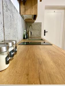 a kitchen with a wooden counter top with two buckets at DOBA RENT Wysockiego 104 in Białystok