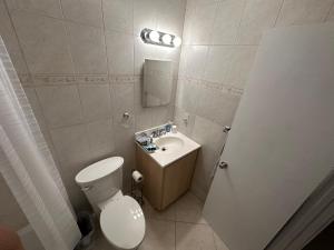 a small bathroom with a toilet and a sink at Elles Place in Fort Lauderdale +13 photos