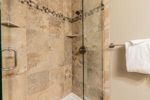 a bathroom with a shower with a glass door at Cimarron 404 by Great Western Lodging in Breckenridge