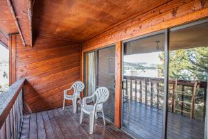 two chairs on the porch of a wooden house at Cimarron 404 by Great Western Lodging in Breckenridge