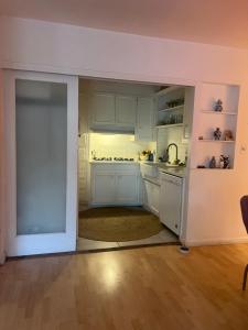 an open kitchen with white cabinets and a sink at Laurel house weho historic district in Los Angeles