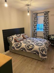 a bedroom with a bed and a window at Home by the Liffey in Dublin