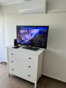 a white dresser with a flat screen tv on it at Sétány Kuckó Apartman in Balatonfüred