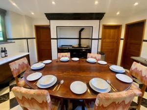 a dining room table with plates and chairs around it at Weston at Lulworth Cove in Lulworth Cove +17 photos