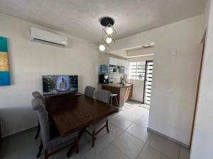 a dining room with a wooden table and chairs at Casa ISLA RODAS Altavela II in Los Algodones