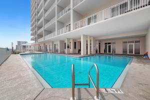 a large swimming pool in front of a building at Windemere Unit 605 in Pensacola