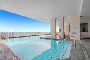 a large pool with blue water in a building at Windemere Unit 605 in Pensacola