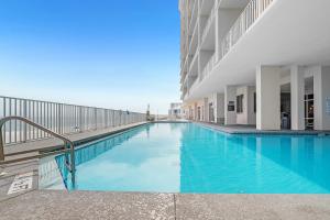 a swimming pool in a building with blue water at Windemere Unit 605 in Pensacola