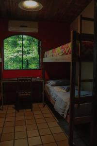 a bedroom with two bunk beds and a window at Albergue Cultural São Salomão in Recife