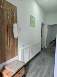 a hallway with white walls and a wooden floor at Riverstone Retreat in Jajce