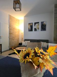 a bouquet of sunflowers on a table in a living room at Riverstone Retreat in Jajce