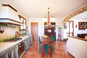 a kitchen with a table and a stove top oven at Villa Pedra Moro in Alghero +30 photos