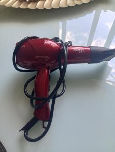a red umbrella is tied to a table at Apartamento em Uruguaiana in Uruguaiana +9 photos