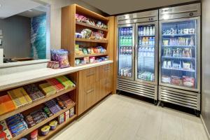 a kitchen with a refrigerator and some food at SPRINGHILL SUITES by Marriott Port St Lucie in Carlton