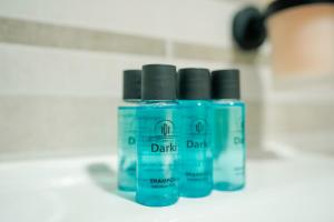 three bottles of dark paint sitting on a counter at Darki Apartments 2 - Very Central Stay With Free Parking in Ohrid