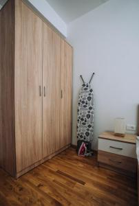 a room with a wooden cabinet and a vase at Darki Apartments 2 - Very Central Stay With Free Parking in Ohrid