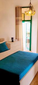 a bedroom with a bed with a desk and a window at Apartment Center Tirana in Tirana
