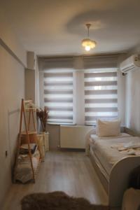 a bedroom with a bed and a window with blinds at ERKUL OLD CITY in Istanbul