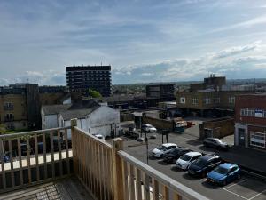 einen Balkon mit Blick auf einen Parkplatz mit Autos in der Unterkunft Maidstone City Centre Penthouse Apartment in Kent