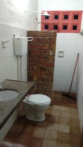 a bathroom with a toilet and a sink at Casa de praia Vera in Caucaia +4 photos