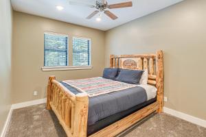 a bedroom with a wooden bed and a ceiling fan at Star Valley Ranch Vacation Rental with Resort Perks! in Thayne