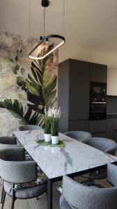 a dining room with a marble table and chairs at Villa Onari in Alexandroupoli