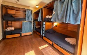 a room with four bunk beds in a room at ITH Adventure Hostel San Diego in San Diego
