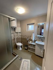 a bathroom with a toilet and a sink at Apartmani Vera in Vinci +68 photos