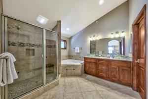 a bathroom with a shower and a tub and a sink at Tahoe Woods 203 at Stateline Heavenly Slopes Lake in South Lake Tahoe +32 photos