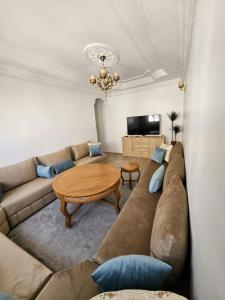 a living room with a couch and a table at Cosy and Complete Casa appartment in Casablanca