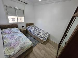 a bedroom with two beds and a window at Cosy and Complete Casa appartment in Casablanca
