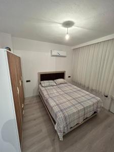 a bedroom with a bed and a cabinet in it at Kırevi-Airport in Ortaca