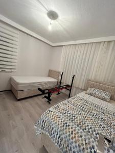 a bedroom with two beds and a window with curtains at Kırevi-Airport in Ortaca