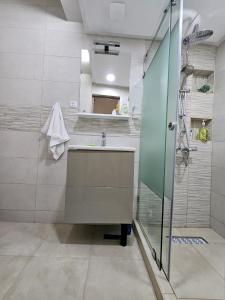 a bathroom with a sink and a shower at Cosy and Complete Casa appartment in Casablanca