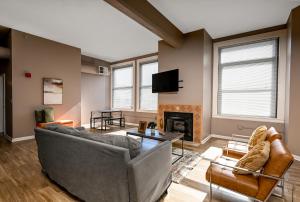 a living room with a couch and a fireplace at 2 bath Prkg+Gym+Sauna Perk Plaza +30 Day in Cleveland