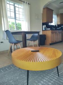 a circular table in a living room with two chairs at LittleLux Living in George Hill