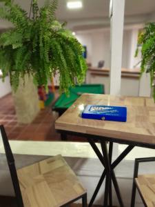 a wooden table with a blue box on top of it at Hotel Pousada Casacolina in Búzios