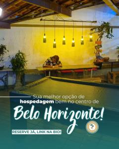 a poster for a restaurant with a person sitting at a table at Savassi Hostel in Belo Horizonte