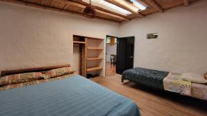a bedroom with a bed and a closet and shelves at Hotel Ecológico La Antigua in San Agustín