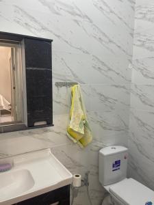 a white bathroom with a sink and a toilet at Guest house with mountain view in Pokrovka