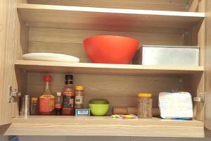 a cupboard with a bowl and other kitchen items at Ecohome 5 wilderness within sight of the Airport in Nairobi