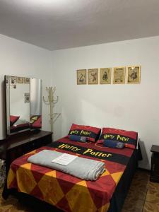 - une chambre avec un lit et une couverture colorée dans l'établissement Aconchego do Harry Potter, à Pomerode