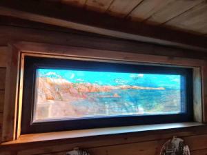 a painting of a fish tank on a wall at Cosy Cornish Cabin in St Austell