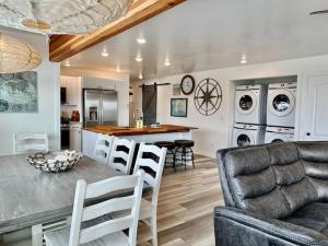 a kitchen and living room with a table and chairs at Seafarer Suites in Homer